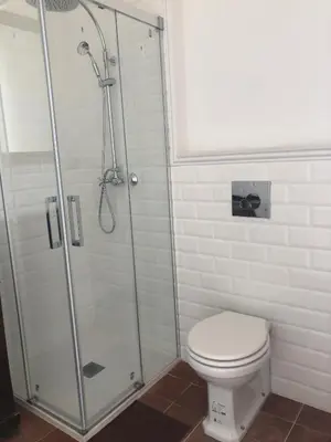 a bathroom with a shower and a toilet at Casa l'àvia - Sant Pol de Mar in San Pol de Mar