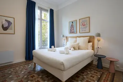 a bedroom with a large white bed and a window at 12DIA1008 - Fantastic Apartment in Diagonal in Barcelona