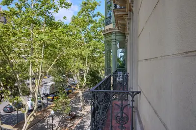 an apartment balcony with a clock on a building at 12DIA1008 - Fantastic Apartment in Diagonal in Barcelona