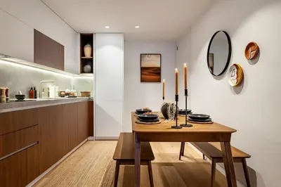 a table with chairs and a vase on it at Tinghir - 2 bedrooms and pool in Gràcia in Barcelona