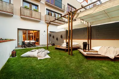 a patio with a swimming pool and two chairs at Tinghir - 2 bedrooms and pool in Gràcia in Barcelona