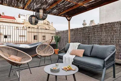 a patio with a couch and chairs and a table at Atacama - 1 bedroom in Eixample Esquerra in Barcelona