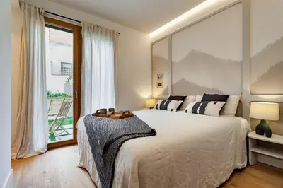 a kitchen with a table and a dining room at Pasir - 2 bedrooms and terrace in Gràcia in Barcelona