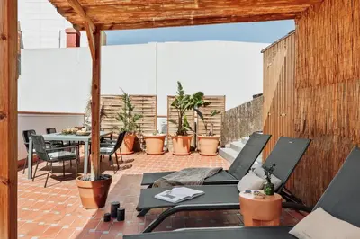 a dining room with a table and a chandelier at Tenere - 1 bedroom and pool in Gràcia in Barcelona