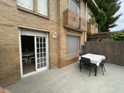 a patio with a table and chairs in front of a building at Habitación Winahost Sant Cugat in Sant Cugat del Vallès