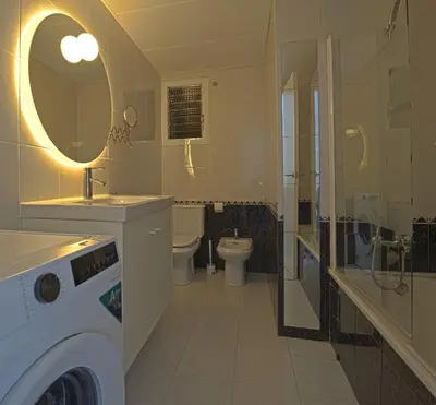 a bathroom with a sink and a toilet and a mirror at Winahost Barcelona Sants in Barcelona