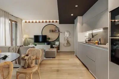 a kitchen with a table with a bottle of wine at Mawun - 2 bedrooms in Gràcia in Barcelona