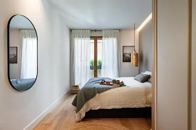 a kitchen with black cabinets and a sink at Oetune - 2 bedrooms and office in Gràcia in Barcelona