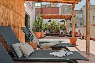 a bedroom with a bed with two pendant lights at Oetune - 2 bedrooms and office in Gràcia in Barcelona