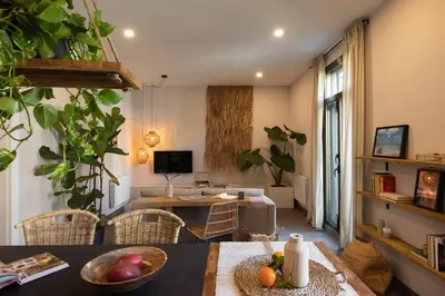 a bedroom with a bed and a mirror and a chair at Damar - 2 bedrooms and balcony in Eixample Dreta in Barcelona