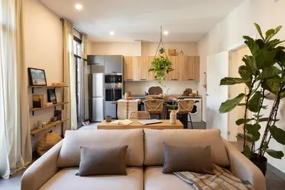 a bedroom with a bed and two pendant lights at Damar - 2 bedrooms and balcony in Eixample Dreta in Barcelona