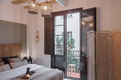 a kitchen with a wooden table and chairs at Velez - 1 bedroom in Gràcia in Barcelona