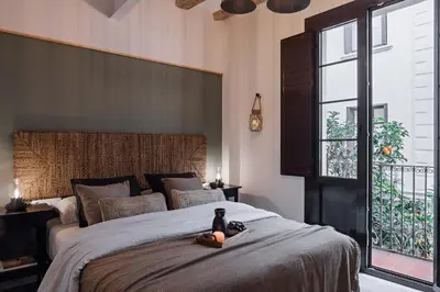 a kitchen and living room with a table and some lights at Velez - 1 bedroom in Gràcia in Barcelona