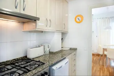 a kitchen with a stove and a counter top at Attic with terrace Barcelona center in Barcelona