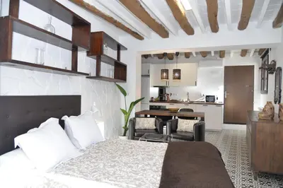 a bedroom with a bed and a living room at Barcelona Badalona Relax PLAYA y METRO in Badalona