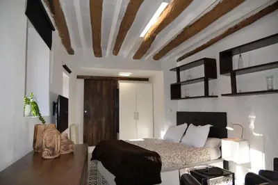 a bedroom with a bed and a wooden ceiling at Barcelona Badalona Relax PLAYA y METRO in Badalona