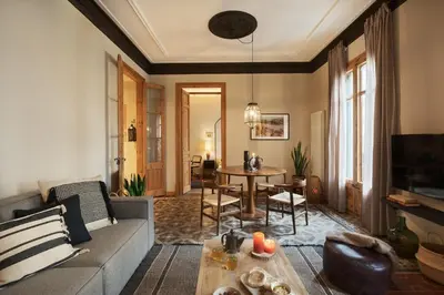 a living room with a couch and a table at Amazzer - 3 bedrooms in Eixample Esquerra in Barcelona