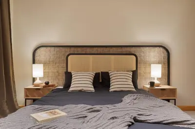 a bedroom with a bed and a chair and a window at Amazzer - 3 bedrooms in Eixample Esquerra in Barcelona