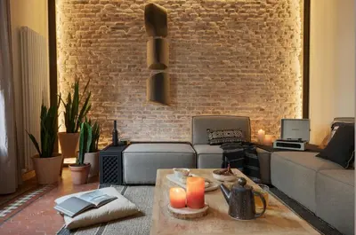 a living room with a brick wall at Amazzer - 3 bedrooms in Eixample Esquerra in Barcelona