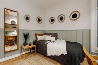 a bedroom with a bed and a mirror and a table at Laurel - 3 bedrooms in Sant Gervasi in Barcelona