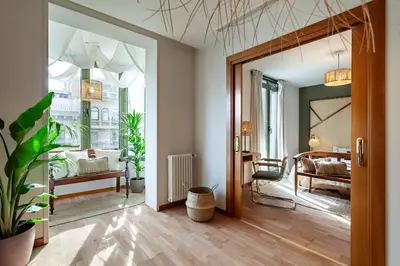 a living room with a couch and a tv at Sipura - 3 bedrooms and balcony in Eixample Dreta in Barcelona