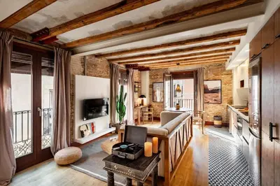 a living room with a couch and a tv at Shan - 1 bedroom and balcony in El Born in Barcelona
