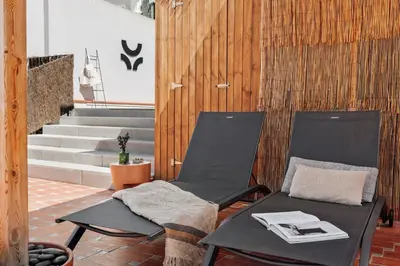a room with a mirror and a white wall at Merzouga - 1 bedroom, a pool and terrace in Gràcia in Barcelona