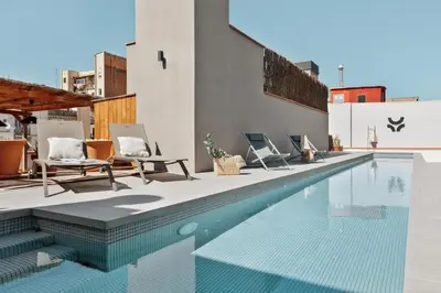 a chair sitting on the side of a building at Merzouga - 1 bedroom, a pool and terrace in Gràcia in Barcelona