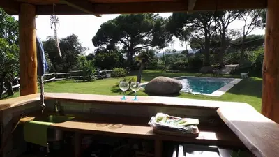 a patio with a table and chairs and plants at La Casita - Boutique Retreat Barcelona Coast Sea View in Sant Andreu de Llavaneres
