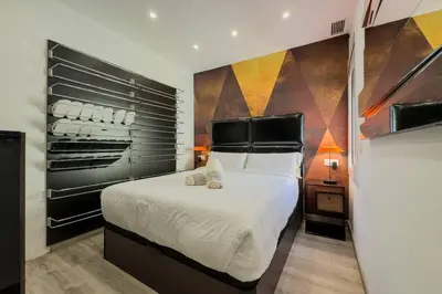 a bedroom with a bed and a painting on the wall at Comfort, Style & Value near Barceloneta Beaches in Barcelona