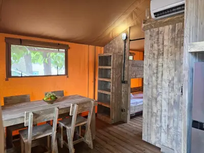 a bedroom with a bed with two pillows and a window at Camping Costa Dorada Tienda Lua in Canet de Mar