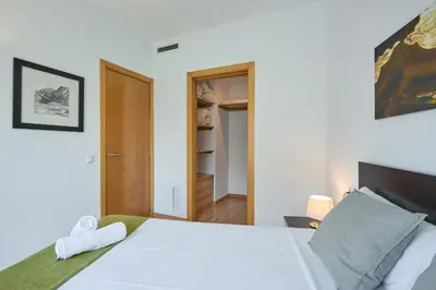 a bedroom with a white bed and a closet at 1IND1011 - One bedroom apartment in Barcelona