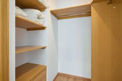 a closet with wooden shelves and a bed in it at 1IND1011 - One bedroom apartment in Barcelona