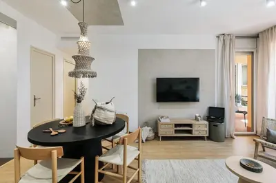 a living room with a table and a couch at Agnello - 3 bedrooms and office in Sant Gervasi in Barcelona