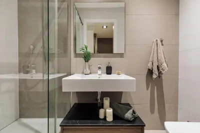 a bedroom with a bed and two lamps and a mirror at Bayal - 2 bedrooms and balcony in El Putxet in Barcelona