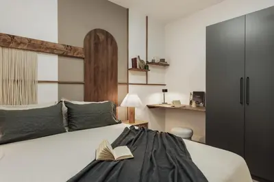 a hallway with a mirror and a bag on a wall at Briso - 3 bedrooms and balcony in Vila de Gràcia in Barcelona