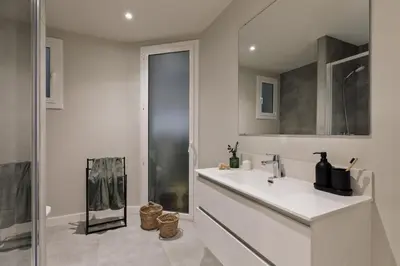 a white bathroom with a sink and a shower at Jabillos - 2 bedrooms and balcony in El Putxet in Barcelona