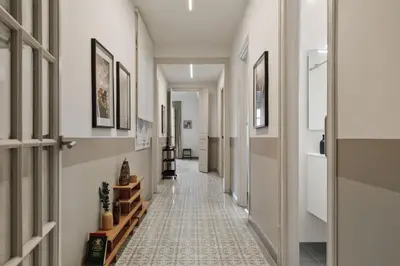 a bedroom with a large bed and a lamp at Kaftan - 5 bedrooms and balcony in Eixample Dreta in Barcelona