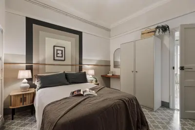 a bedroom with a large bed and a mirror at Kaftan - 5 bedrooms and balcony in Eixample Dreta in Barcelona