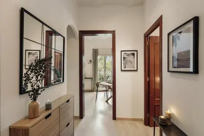 a dining room with a table with a vase on it at Nampi - 2 bedrooms and balcony in El Poblenou in Barcelona