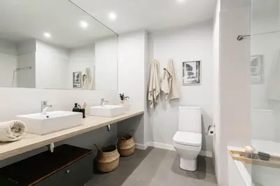 a bedroom with a bed and a desk with a lamp at Ravello - 3 bedroom and terrace in Sant Gervasi in Barcelona