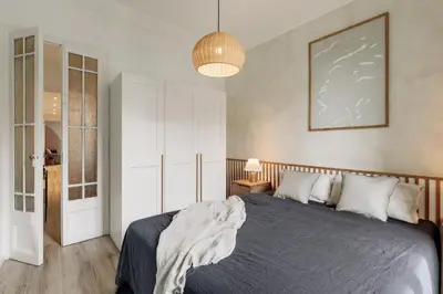 a living room with a chair and a mirror at Tulum - 3 bedrooms and balcony in Gràcia in Barcelona