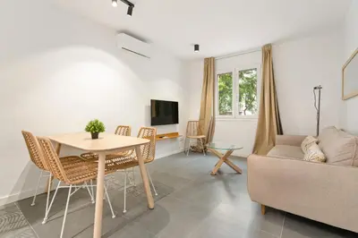 a living room with a table and a couch at Flateli Espronceda 01 in Barcelona