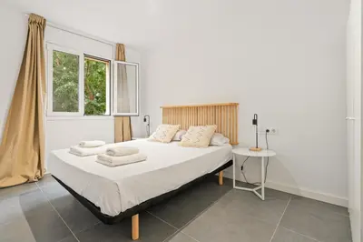 a bedroom with a large bed and a window at Flateli Espronceda 11 in Barcelona