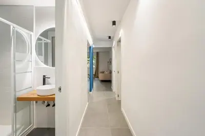 a hallway leading to a bathroom with a sink at Flateli Espronceda 22 in Barcelona