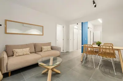 a living room with a couch and a table and chairs at Flateli Espronceda 22 in Barcelona