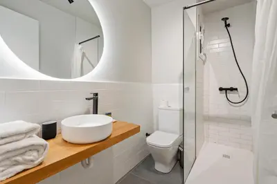 a bathroom with a sink and a toilet and a mirror at Flateli Espronceda 22 in Barcelona