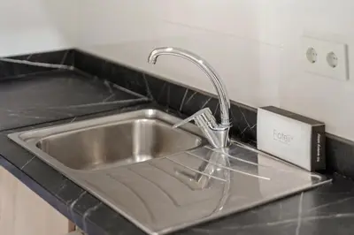 a kitchen sink with a faucet on a counter at Flateli Espronceda 32 in Barcelona