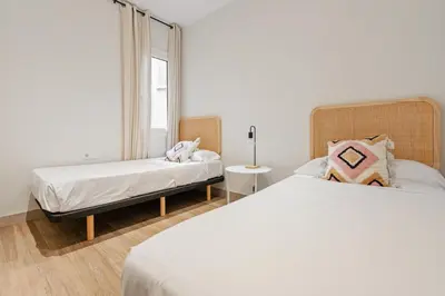 a bedroom with two beds and a window at Flateli Espronceda 32 in Barcelona