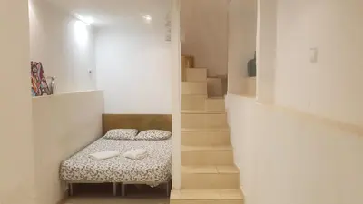 a small room with a bench with shoes on it at 016 DUPLEX centric in Barcelona